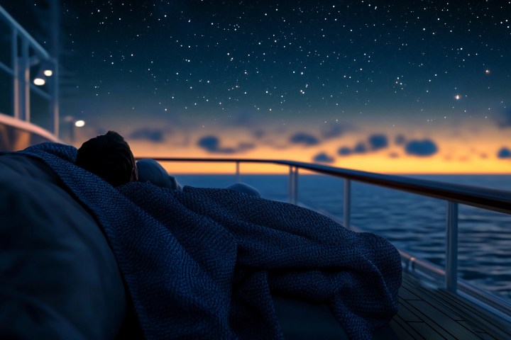 a person sitting in front of a sunset