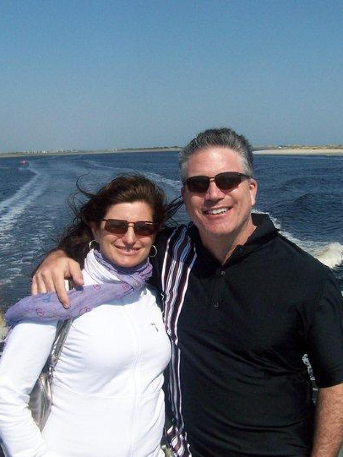 a man standing next to a body of water