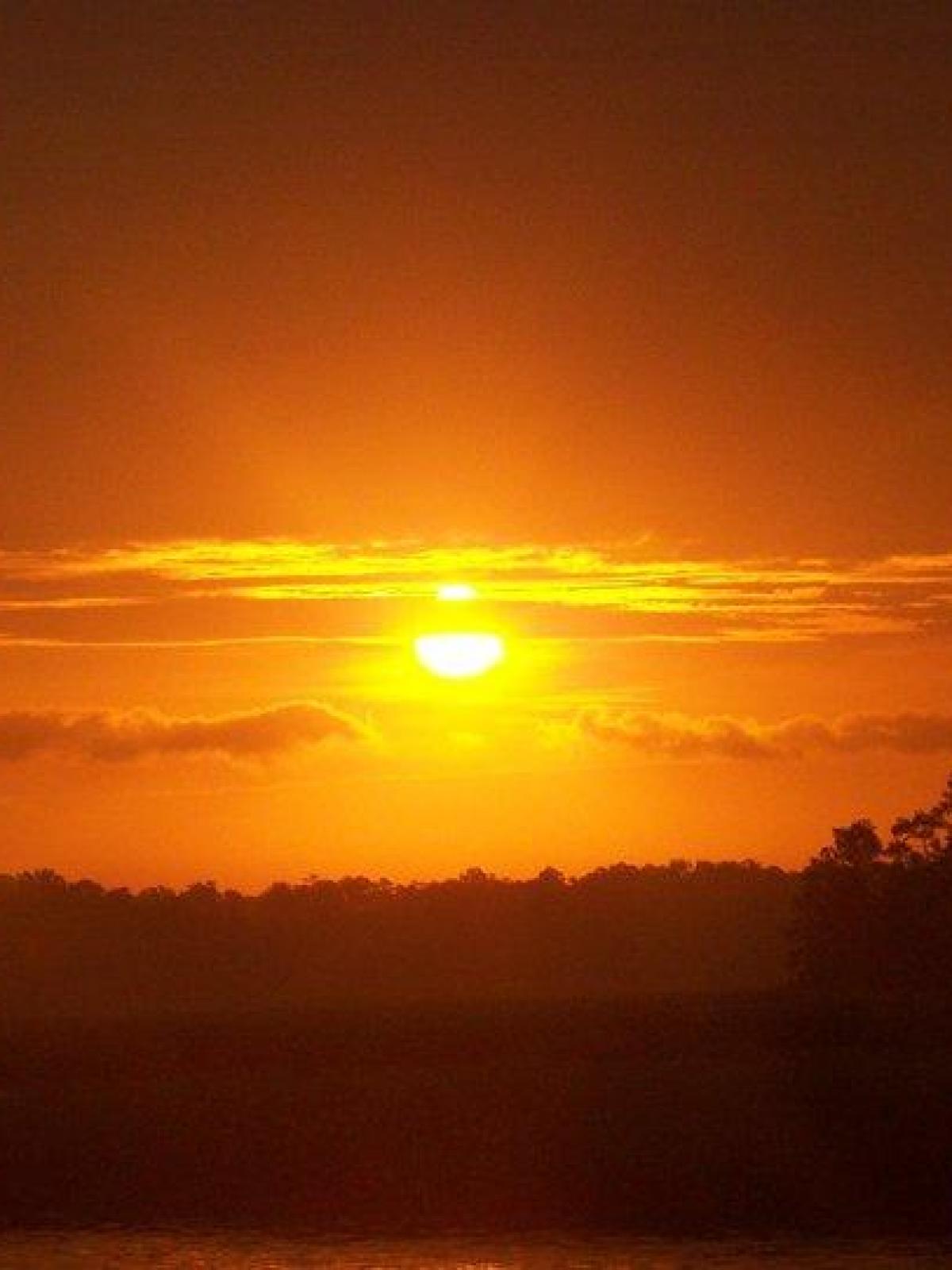 a sunset over a body of water